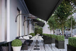 Bromic Eclipse Electric heaters on wall mount poles warming an outdoor cafe seating area