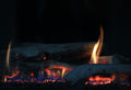 Glowing gas fireplace logs, comparing Grand Canyon Gas Logs and Real Fyre indoor vs outdoor warranty coverage