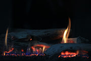 Glowing gas fireplace logs, comparing Grand Canyon Gas Logs and Real Fyre indoor vs outdoor warranty coverage