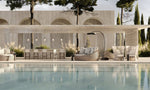 Bromic Eclipse Portable electric freestanding heater beside an outdoor pool lounge at dusk