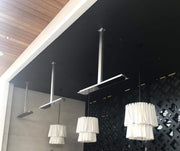 Bromic Platinum Electric heaters suspended from ceiling poles over a restaurant patio